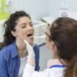 female patient opening her mouth doctor look her throat otolaryngologist examines sore throat patient 650x650 1 85x85