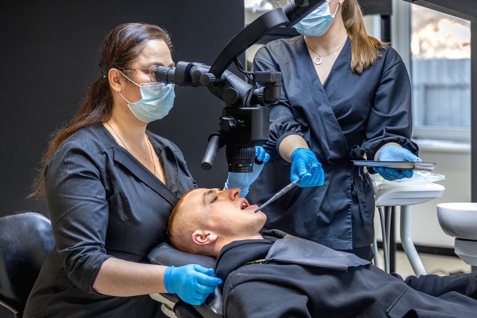 team dentists treats patients teeth using modern equipment dentistry concept scaled